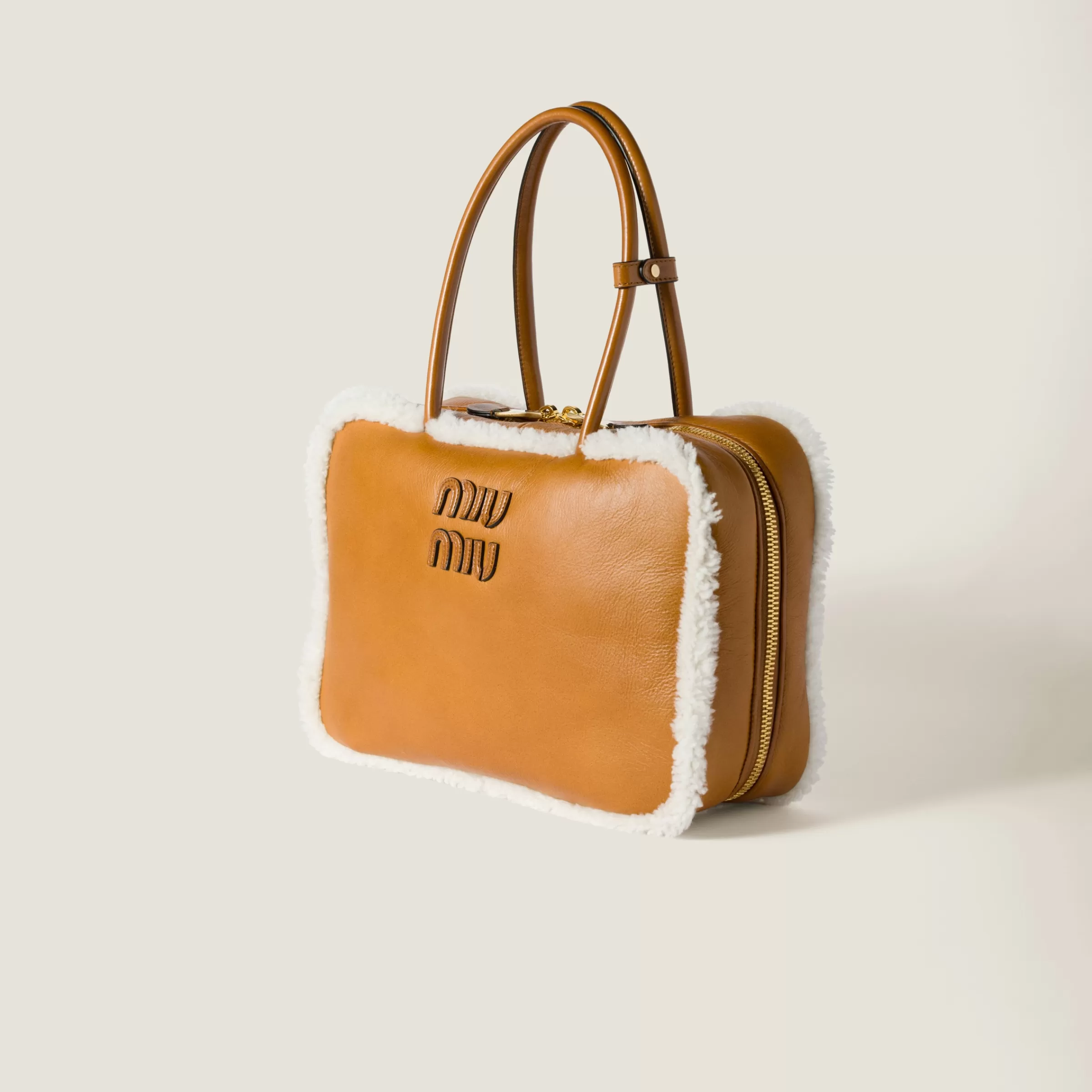 Beau shearling top-handle bag>Miu Miu Shop